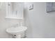 Bathroom featuring a pedestal sink, wall mirror, and decorative wall art at 714 Cupola Dr, Raleigh, NC 27603