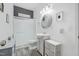 Well-lit bathroom featuring gray accents, modern fixtures, and a shower with glass door at 714 Cupola Dr, Raleigh, NC 27603