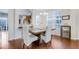 Dining area features wood floors, a modern chandelier, with a breakfast bar view into kitchen at 714 Cupola Dr, Raleigh, NC 27603