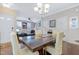 Light-filled dining area with wood floors, complemented by a chandelier and views to the living room at 714 Cupola Dr, Raleigh, NC 27603