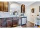 Functional kitchen design featuring dark wood cabinetry, stainless steel appliances, and tile backsplash at 714 Cupola Dr, Raleigh, NC 27603