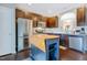 Well-equipped kitchen featuring stainless steel appliances and dark wood cabinetry, with an island and a view of the dining area at 714 Cupola Dr, Raleigh, NC 27603