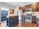 A well-appointed kitchen with stainless steel appliances, wood cabinets, and an island for extra prep space at 714 Cupola Dr, Raleigh, NC 27603