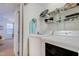 Bright laundry room with white washer and dryer and wire shelving for optimal storage at 714 Cupola Dr, Raleigh, NC 27603