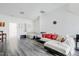 Spacious living room features gray vinyl floors, a comfortable sofa, and bright white walls at 714 Cupola Dr, Raleigh, NC 27603