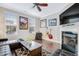 A cozy living room featuring hardwood floors, a fireplace, tasteful artwork, and a ceiling fan at 714 Cupola Dr, Raleigh, NC 27603