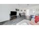 Open living room with gray vinyl floors, a large TV, and comfortable seating arrangement at 714 Cupola Dr, Raleigh, NC 27603