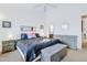 Spacious main bedroom showcasing ample natural light, a tufted bed frame, and a coordinating gray dresser at 714 Cupola Dr, Raleigh, NC 27603