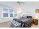 Bright main bedroom with a ceiling fan, large windows, and a luxurious upholstered bed at 714 Cupola Dr, Raleigh, NC 27603
