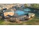 Aerial view of a beautiful blue swimming pool with surrounding buildings and tennis courts at 714 Cupola Dr, Raleigh, NC 27603