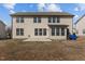 Exterior view of the home's rear facade and concrete patio overlooking the grassy backyard at 714 Fairway Dr, Mebane, NC 27302