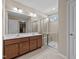 Bathroom featuring double sinks, a glass shower and tile flooring at 714 Fairway Dr, Mebane, NC 27302