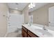 Bathroom featuring double sinks, a shower, a tub, and tile flooring at 714 Fairway Dr, Mebane, NC 27302