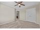 Bedroom with carpet and a ceiling fan, showcasing a bathroom through the open door at 714 Fairway Dr, Mebane, NC 27302