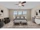 Staged bedroom with neutral color palette, featuring an accent chair and desk at 714 Fairway Dr, Mebane, NC 27302