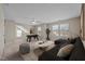 Relaxing bonus room with sofa, accent tables, foosball table and large windows at 714 Fairway Dr, Mebane, NC 27302