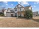 Inviting two-story home boasts a well-maintained lawn, two-car garage, and beautifully landscaped front yard at 714 Fairway Dr, Mebane, NC 27302