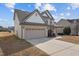 This home features a two-car garage, a well-manicured lawn, and a classic two-story design at 714 Fairway Dr, Mebane, NC 27302
