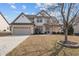 Charming two-story home boasts a well-maintained lawn, two-car garage, and inviting front porch at 714 Fairway Dr, Mebane, NC 27302