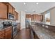 Well-equipped kitchen with stainless steel appliances, granite countertops, and ample cabinet space at 714 Fairway Dr, Mebane, NC 27302