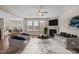 Spacious living room with a cozy fireplace, plush seating, and seamless flow to the dining area at 714 Fairway Dr, Mebane, NC 27302
