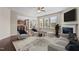 Bright living space with fireplace, large windows, and stylish furnishings seamlessly connects to the kitchen at 714 Fairway Dr, Mebane, NC 27302