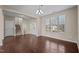 Open-concept living room featuring hardwood floors and tons of natural light with staircase and entry view at 714 Fairway Dr, Mebane, NC 27302
