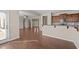 Open-concept area featuring hardwood floors with a partial kitchen, entry, and living space view at 714 Fairway Dr, Mebane, NC 27302