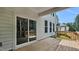 Back porch boasts a wooden deck with railings and sliding glass doors with a view of the backyard at 7521 Percussion Dr, Apex, NC 27539