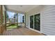 Outdoor back porch with wood decking, railings, offering an inviting space for relaxation and entertaining at 7521 Percussion Dr, Apex, NC 27539