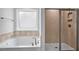 Bathroom boasting a soaking tub and separate glass shower at 7521 Percussion Dr, Apex, NC 27539