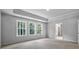 Bright bedroom showcasing neutral paint and three sunlit windows at 7521 Percussion Dr, Apex, NC 27539