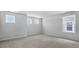 Well-lit bedroom displaying carpet and multiple windows at 7521 Percussion Dr, Apex, NC 27539