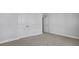 Spacious bedroom with neutral carpet, white trim, and double door closet at 7521 Percussion Dr, Apex, NC 27539