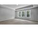 Spacious carpeted bedroom featuring a tray ceiling and bright windows at 7521 Percussion Dr, Apex, NC 27539
