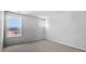 Bright bedroom featuring neutral carpeting, natural light from large window, and a calming atmosphere at 7521 Percussion Dr, Apex, NC 27539