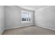 A bright empty bedroom with neutral carpet, a large window with great views at 7521 Percussion Dr, Apex, NC 27539