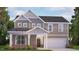 Charming two-story home with stone accents, covered porch, and a two-car garage at 7521 Percussion Dr, Apex, NC 27539