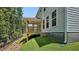 Exterior of home showing porch, backyard, and lush green grass, perfect for outdoor enjoyment at 7521 Percussion Dr, Apex, NC 27539