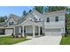 Charming two-story home with a welcoming front porch and well-manicured lawn at 7521 Percussion Dr, Apex, NC 27539