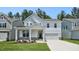 Charming two-story home with a welcoming front porch and well-manicured lawn at 7521 Percussion Dr, Apex, NC 27539