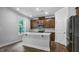 Modern kitchen featuring stainless steel appliances and hardwood floors at 7521 Percussion Dr, Apex, NC 27539