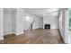 Bright living room with fireplace, modern staircase, and hardwood floors at 7521 Percussion Dr, Apex, NC 27539
