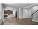 Open concept living area with kitchen and staircase, perfect for entertaining at 7521 Percussion Dr, Apex, NC 27539