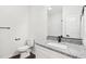 This bathroom includes wood floors, a granite countertop, a toilet, and a mirror at 815 Graham St, Burlington, NC 27217