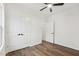 This bedroom has wood floors, a ceiling fan, closet, and a doorway leading to another room at 815 Graham St, Burlington, NC 27217