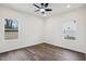 This is a bedroom with wood floors, two windows providing natural light, and a ceiling fan at 815 Graham St, Burlington, NC 27217
