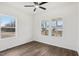 This bedroom features wood floors, two windows providing natural light, and a ceiling fan at 815 Graham St, Burlington, NC 27217