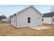 Exterior view of a home showing light gray vinyl siding and a concrete patio at 815 Graham St, Burlington, NC 27217