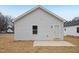 Exterior view of a house showing light gray vinyl siding and a concrete patio slab at 815 Graham St, Burlington, NC 27217